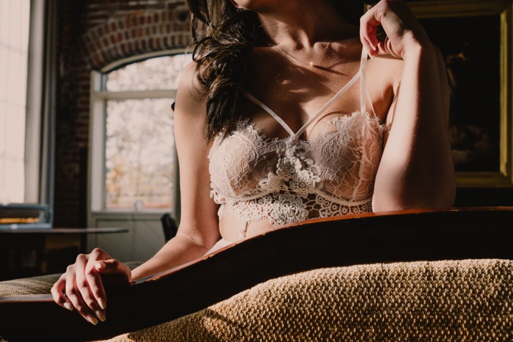 White bridal lingerie being worn by a woman during her boudoir photography session