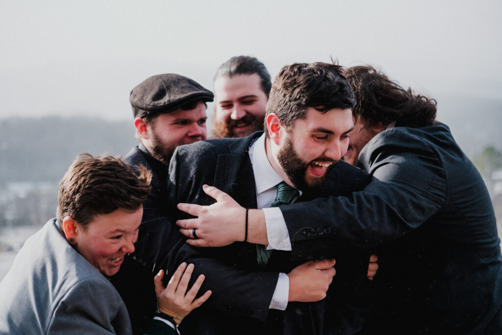 Groom being tackled by the wedding party before his Cove Lake State Park wedding